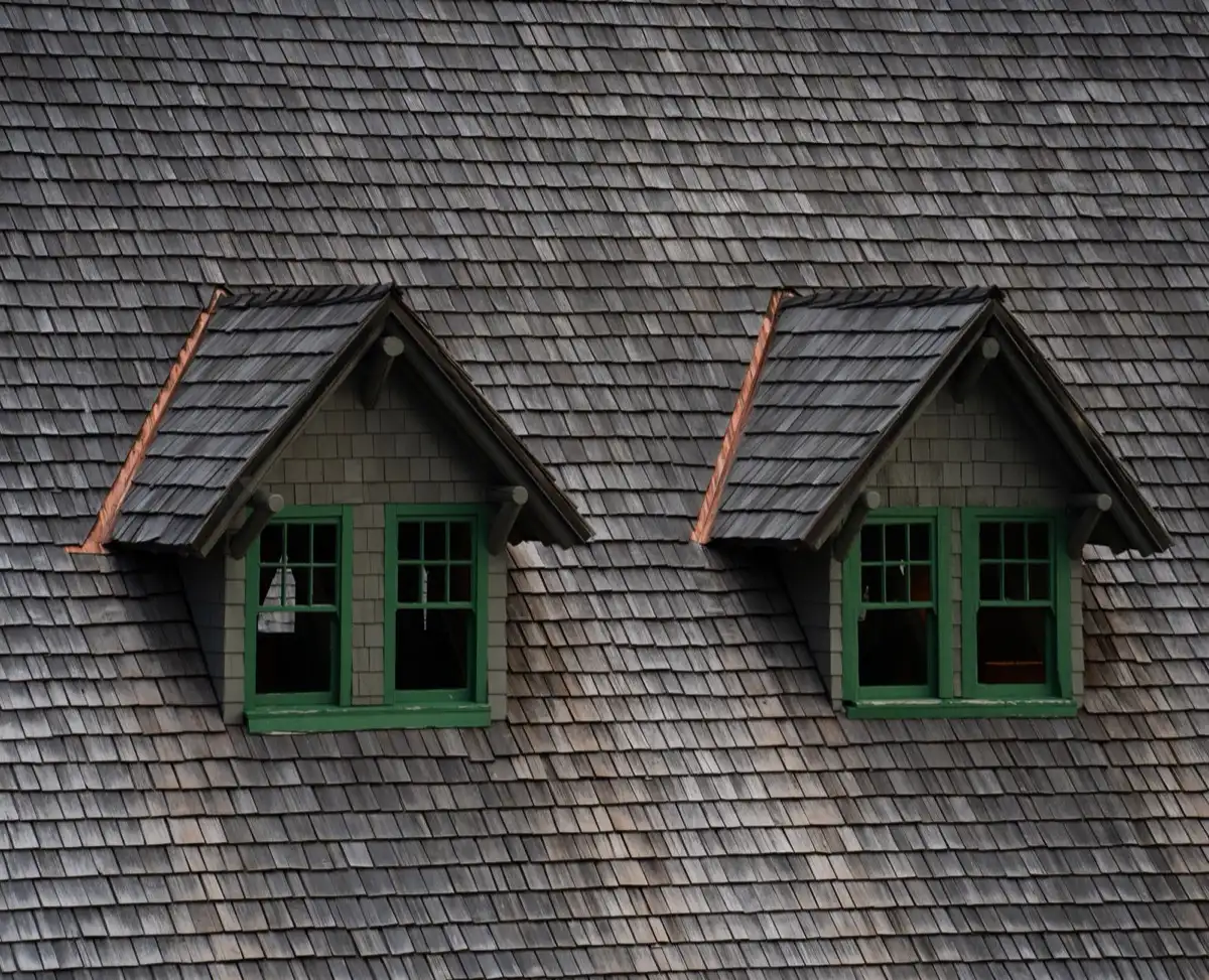 Dormers on a shingle roof in Warwick, RI, where step flashing and kickout flashing carry water past the walls